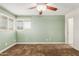 This bedroom features neutral walls, a ceiling fan, and a window that provides plenty of natural light at 6009 W Medlock Dr, Glendale, AZ 85301