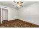 This bedroom features neutral walls, a ceiling fan, and a door to the side of the room at 6009 W Medlock Dr, Glendale, AZ 85301