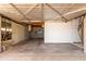 View of the garage showing the open ceiling, cement floor, and open layout at 6009 W Medlock Dr, Glendale, AZ 85301