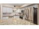 Updated kitchen featuring granite countertops, stainless steel appliances, and stylish backsplash at 6009 W Medlock Dr, Glendale, AZ 85301