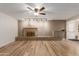 Open-concept living room features a fireplace and wood-look flooring, perfect for gatherings at 6009 W Medlock Dr, Glendale, AZ 85301