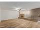 Bright living room features a cozy fireplace and wood-look flooring, creating a welcoming ambiance at 6009 W Medlock Dr, Glendale, AZ 85301