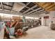 Spacious storage area featuring ample shelving, a lawnmower, and a variety of gardening equipment and tools at 6009 W Medlock Dr, Glendale, AZ 85301