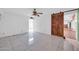 Bedroom with a rustic wood sliding door, ceiling fan and white brick wall at 6217 W Orange Dr, Glendale, AZ 85301
