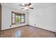 This bedroom offers a bay window with natural light, complemented by hardwood floors, creating a bright and inviting space at 6217 W Orange Dr, Glendale, AZ 85301