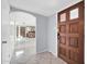Welcoming entryway with tile flooring, a wood door, and an archway that leads to the bar area and main living space at 6217 W Orange Dr, Glendale, AZ 85301