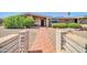 Charming single-story home featuring a brick pathway and inviting front entrance, with mature landscaping at 6217 W Orange Dr, Glendale, AZ 85301