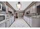 Bright kitchen with neutral cabinetry, granite countertops, mosaic backsplash, and skylight at 6217 W Orange Dr, Glendale, AZ 85301
