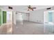 Bright living room featuring white brick walls, tiled floor, and a ceiling fan at 6217 W Orange Dr, Glendale, AZ 85301