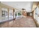 Spacious sunroom with tile flooring, featuring a built-in bar area, french doors and lots of natural light at 6217 W Orange Dr, Glendale, AZ 85301
