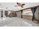 Open living area featuring tile floors, brick accent walls, a stylish bar, and a bright window at 6217 W Orange Dr, Glendale, AZ 85301