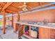 The outdoor kitchen features a built-in sink, a ceiling fan, and a covered area for grilling and entertaining at 6217 W Orange Dr, Glendale, AZ 85301