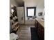 Bathroom with wood vanity, tub with tiled surround, and laminate floor at 625 W Mckellips Rd # 358, Mesa, AZ 85201