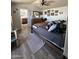 Primary bedroom with wood-look laminate floors, ceiling fan, and multiple decorations at 625 W Mckellips Rd # 358, Mesa, AZ 85201