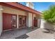 This is a covered back porch featuring decorative red doors and rock landscape at 633 W Southern Ave # 1181, Tempe, AZ 85282