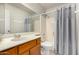 This bathroom has a large mirror, wooden cabinets, and a shower-tub combo at 633 W Southern Ave # 1181, Tempe, AZ 85282