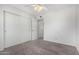 This is a cozy bedroom with neutral carpet, a ceiling fan and a closet at 633 W Southern Ave # 1181, Tempe, AZ 85282