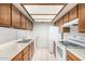 Cozy kitchen featuring classic wood cabinets, white appliances, tiled floors, and a unique lattice-covered skylight at 633 W Southern Ave # 1181, Tempe, AZ 85282