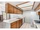 Bright kitchen showcasing ample counter space, wood cabinetry, and a view into the living area with a charming fireplace at 633 W Southern Ave # 1181, Tempe, AZ 85282
