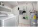 This is a bright laundry room with washer, dryer, shelving, and a water heater at 633 W Southern Ave # 1181, Tempe, AZ 85282