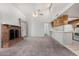 Inviting living room featuring high ceilings, a fireplace, and seamless kitchen access at 633 W Southern Ave # 1181, Tempe, AZ 85282