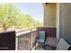 Cozy outdoor balcony with seating and a view of mature trees at 6605 N 93Rd Ave # 1035, Glendale, AZ 85305