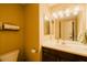 Bathroom featuring vanity with large mirror, ample lighting, modern sink, and dark brown cabinetry at 6605 N 93Rd Ave # 1035, Glendale, AZ 85305