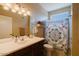 Bright bathroom featuring a shower with a patterned curtain, vanity, and toilet at 6605 N 93Rd Ave # 1035, Glendale, AZ 85305