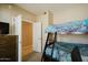 Bright bedroom featuring a wooden bunk bed with decorative blue patterned bedding and an open closet space at 6605 N 93Rd Ave # 1035, Glendale, AZ 85305