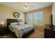 Cozy bedroom with a comfortable bed, ceiling fan, and large windows offering plenty of natural light at 6605 N 93Rd Ave # 1035, Glendale, AZ 85305