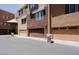 Exterior view of townhomes with individual garages and neutral color schemes at 6605 N 93Rd Ave # 1035, Glendale, AZ 85305