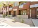 Exterior of a row of townhomes with a gravel yard and concrete walkways, showing multiple units at 6605 N 93Rd Ave # 1035, Glendale, AZ 85305