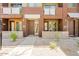 Close-up of the townhome exteriors, showcasing individual entrances and small, xeriscaped yards at 6605 N 93Rd Ave # 1035, Glendale, AZ 85305