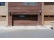 Attached garage with roll-up door, set in a row of townhome garages and well-maintained landscape at 6605 N 93Rd Ave # 1035, Glendale, AZ 85305
