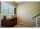 Hallway with carpeted floors, wooden console, and a large window bringing in natural light at 6605 N 93Rd Ave # 1035, Glendale, AZ 85305