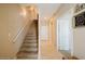 Interior hallway with staircase, light tile flooring, and neutral paint tones at 6605 N 93Rd Ave # 1035, Glendale, AZ 85305
