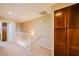 Bright hallway with staircase, featuring modern railing and natural light, storage cabinet, and neutral color palette at 6605 N 93Rd Ave # 1035, Glendale, AZ 85305