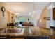 Bright, open kitchen island overlooking the living room space in the background with natural light at 6605 N 93Rd Ave # 1035, Glendale, AZ 85305