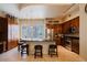 Open-concept kitchen with an island featuring dark countertops, pendant lighting, and stainless steel appliances at 6605 N 93Rd Ave # 1035, Glendale, AZ 85305