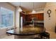 Bright kitchen with an island featuring dark countertops and pendant lighting and modern stainless steel appliances at 6605 N 93Rd Ave # 1035, Glendale, AZ 85305