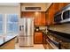 Bright kitchen with stainless steel appliances and a large window next to a light stained butcher block countertop at 6605 N 93Rd Ave # 1035, Glendale, AZ 85305