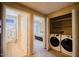 Convenient laundry area with washer and dryer, adjacent to bathroom and bedroom at 6605 N 93Rd Ave # 1035, Glendale, AZ 85305