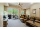 Inviting living room with balcony access featuring neutral tones, ceiling fan, and natural light at 6605 N 93Rd Ave # 1035, Glendale, AZ 85305