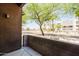 Features a cozy patio space with a low brick wall, and views of landscaping and neighboring buildings at 6605 N 93Rd Ave # 1035, Glendale, AZ 85305