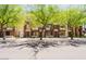 Street view of modern townhomes with well-maintained landscaping and trees along the sidewalk at 6605 N 93Rd Ave # 1035, Glendale, AZ 85305