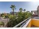 Balcony view of a city street, palm trees, and a building at 706 E Washington St # 124, Phoenix, AZ 85034
