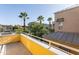 Sunny balcony showcasing clear skies, lush greenery, and nearby buildings at 706 E Washington St # 124, Phoenix, AZ 85034