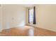 Vacant bedroom with laminate flooring, a single window, neutral wall color, and a simple curtain at 706 E Washington St # 124, Phoenix, AZ 85034