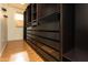 Walk-in closet with floor-to-ceiling dark wood organizers and hardwood flooring at 706 E Washington St # 124, Phoenix, AZ 85034