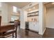Bright dining area with dark wood floors, a custom bar, and views into an adjacent living room at 706 E Washington St # 124, Phoenix, AZ 85034